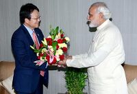 Modi presents flowers to the South Koren ambassador