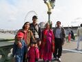 family group at at Westminster Bridge, London Eye seen behind