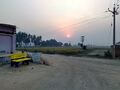 The Western side of the village with a sign board leading to Rasidan (Haryana).